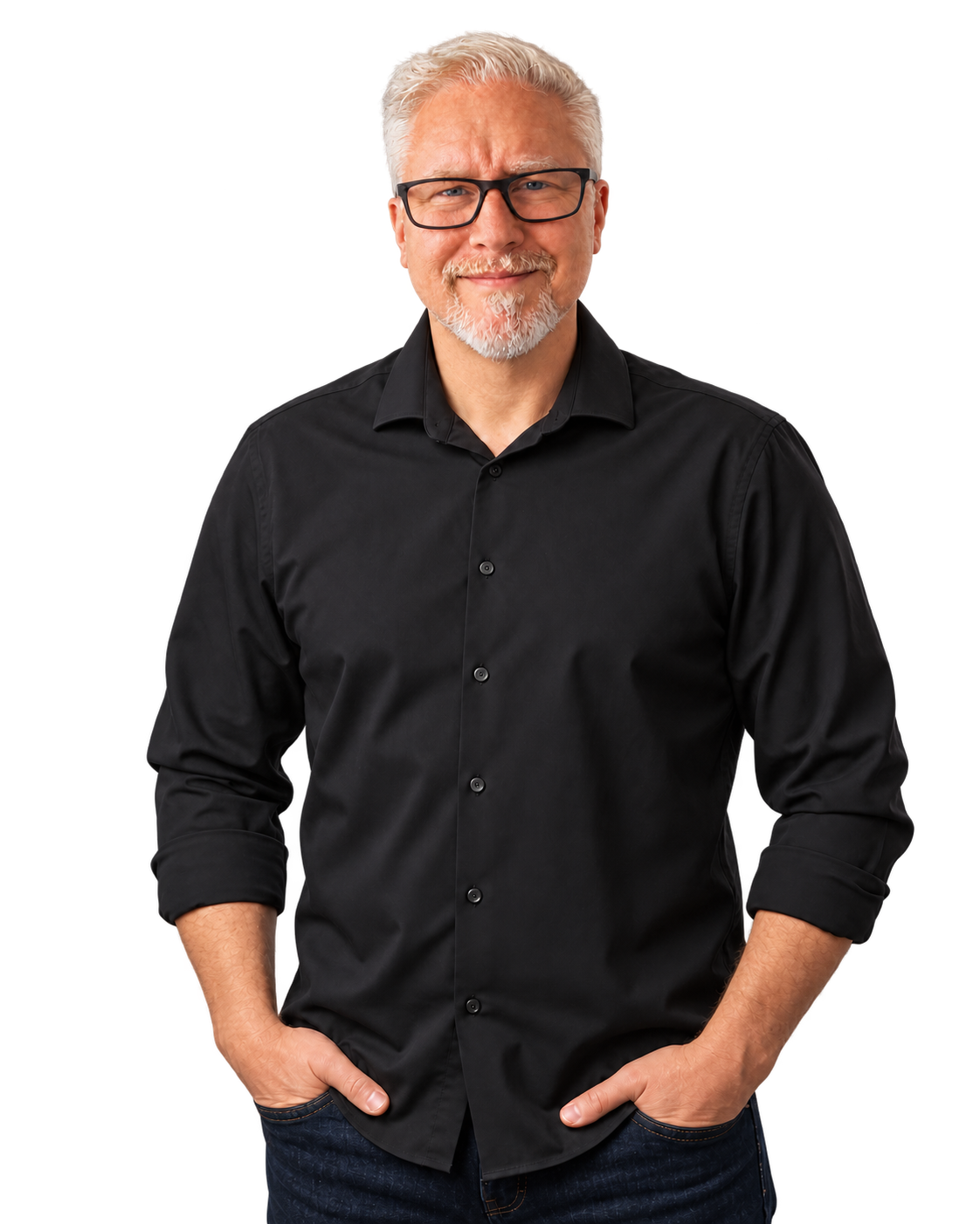 Eric Thompson, wearing glasses and a black shirt, smiling with his hands in his pockets